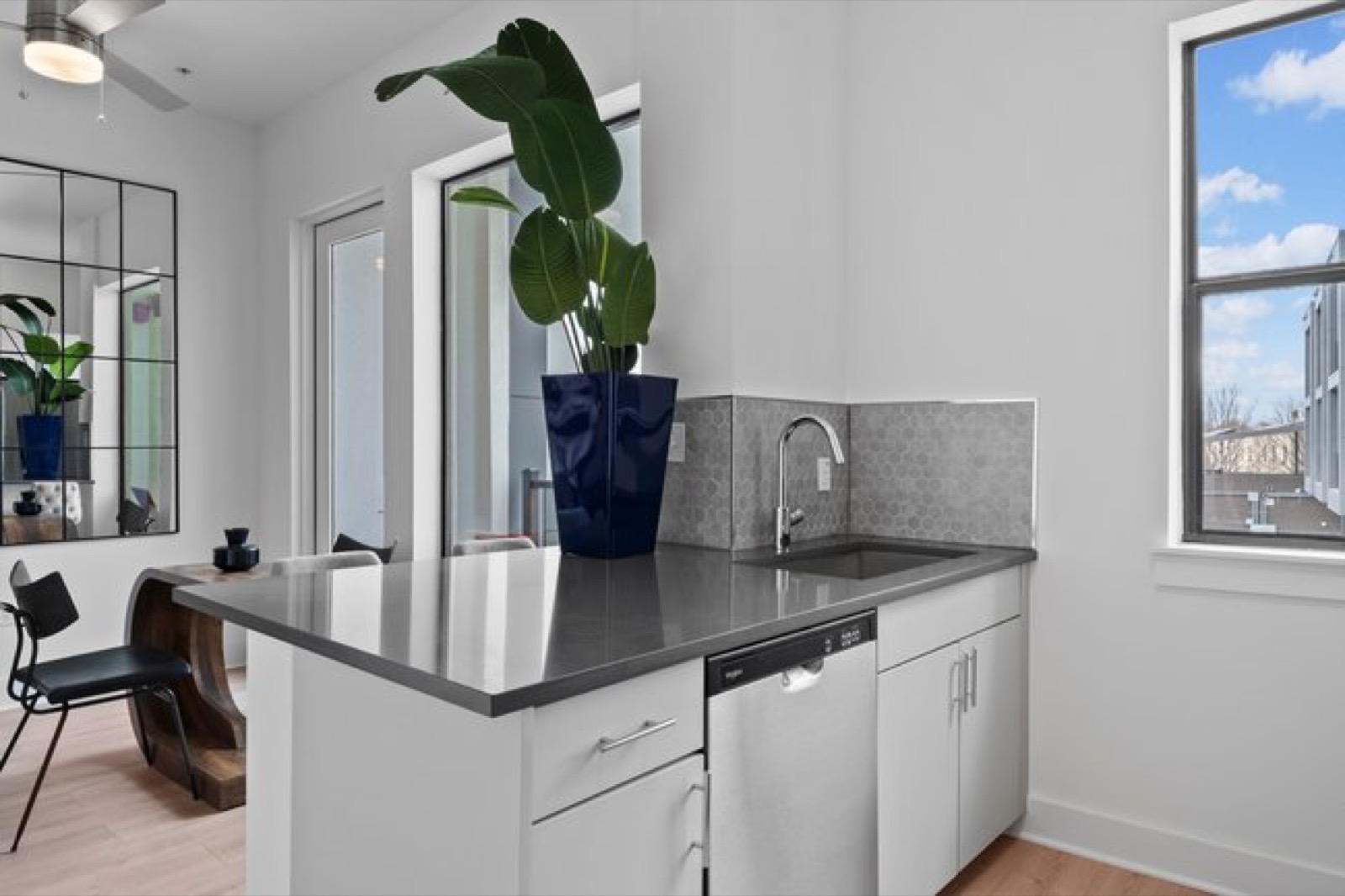 Kitchen island with tile backsplash in Unit 211
