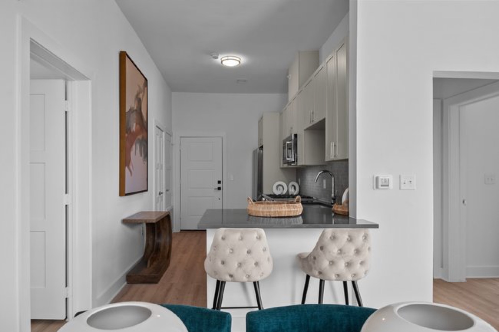 Kitchen with island seating and entry in Unit 303