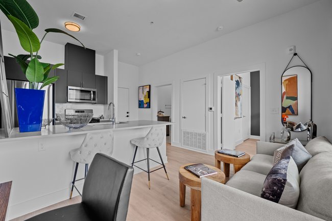 Open-concept living area in Unit 208