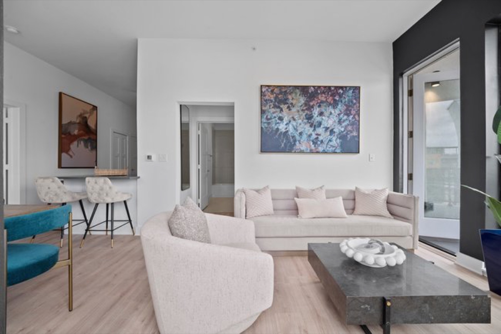 Spacious living area with balcony access in Unit 303